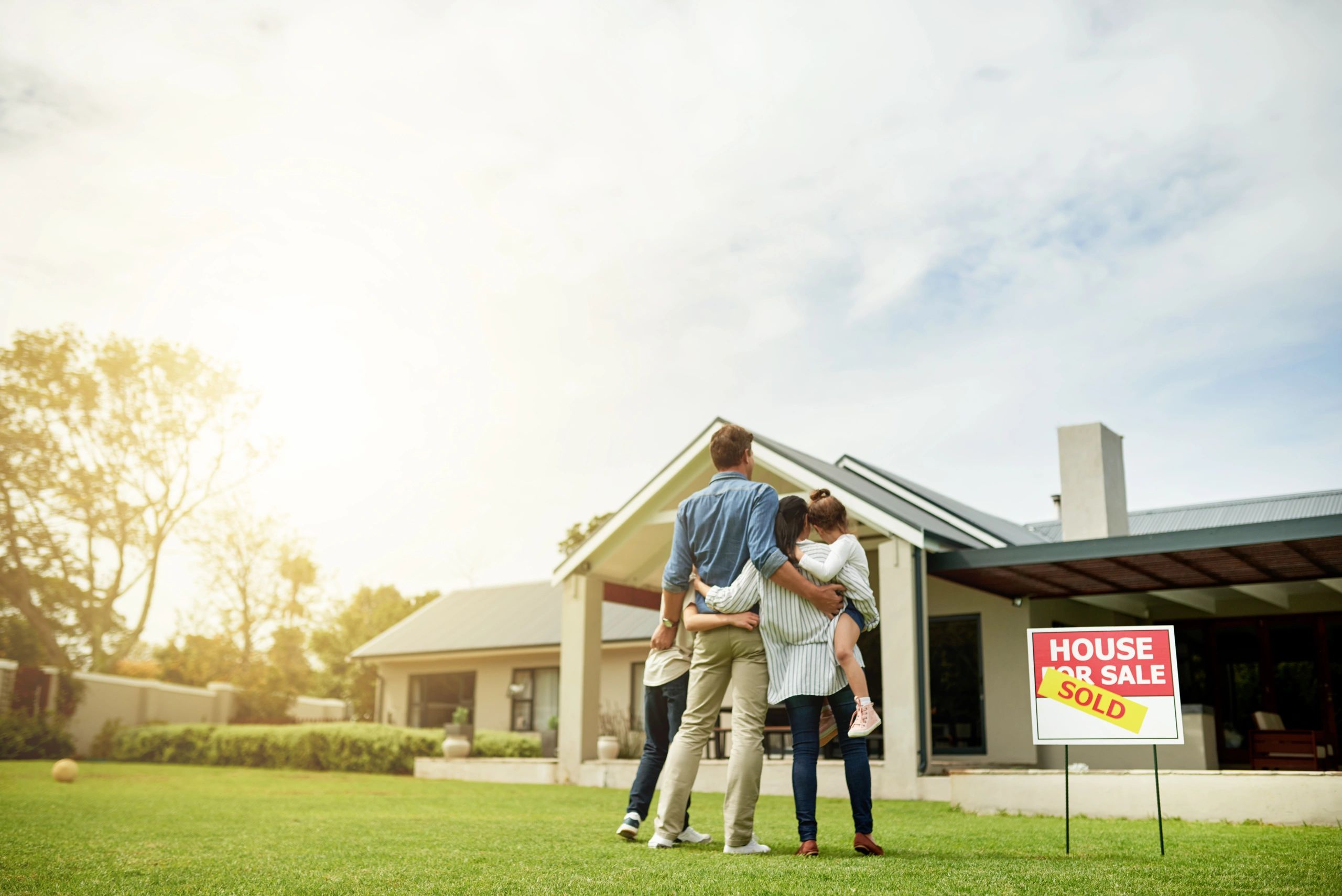 family looking at new home exterior