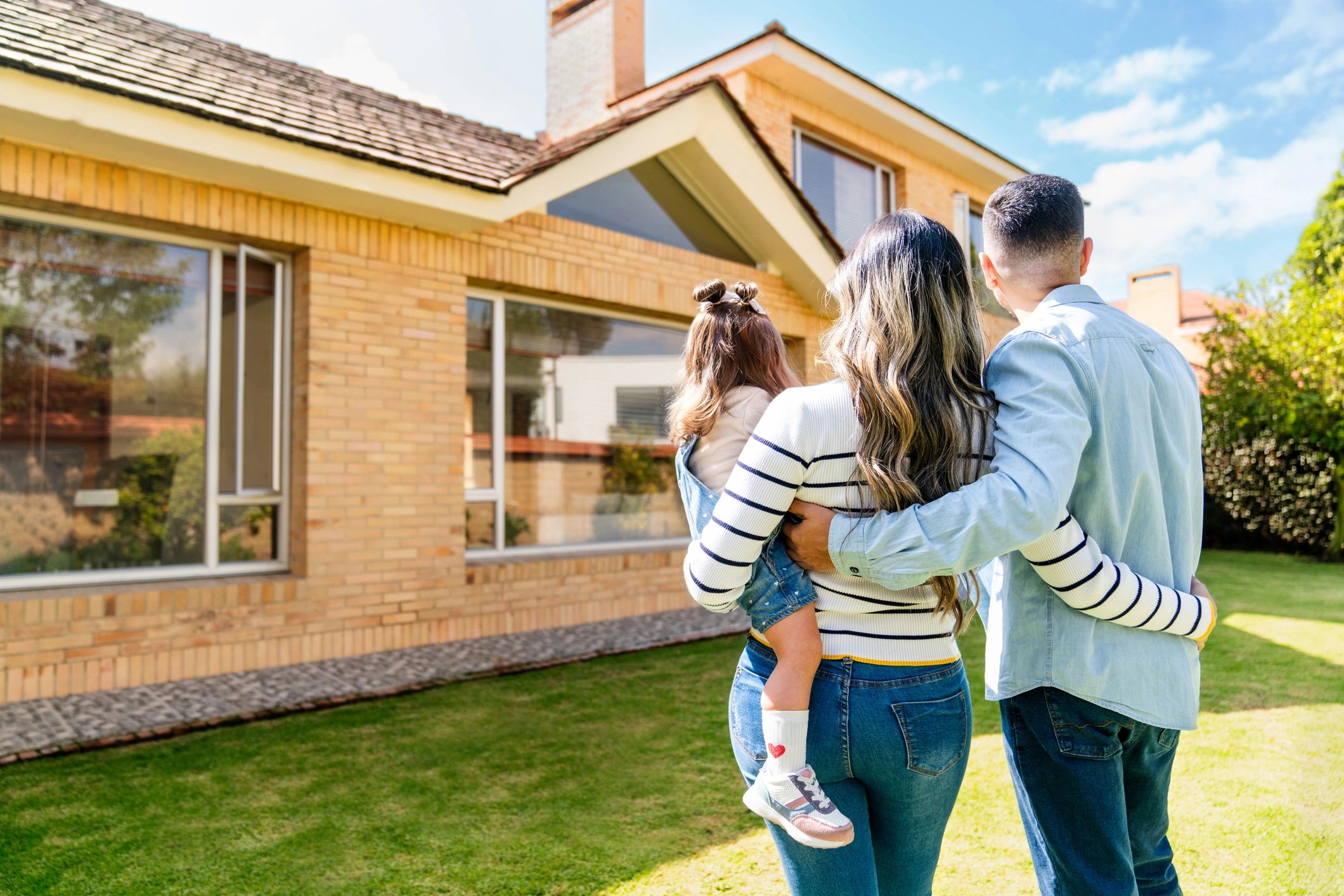 family looking at new home exterior