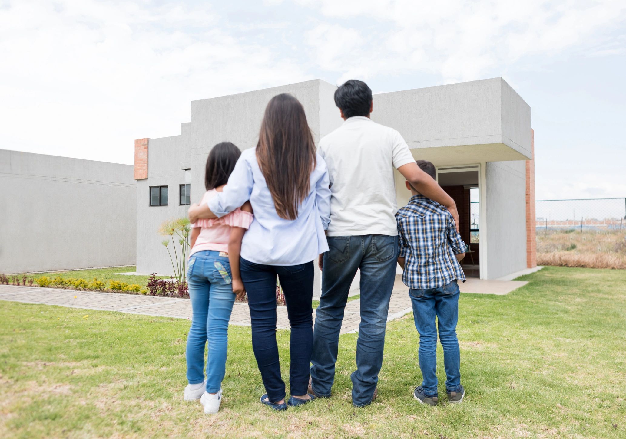 family looking at new home exterior