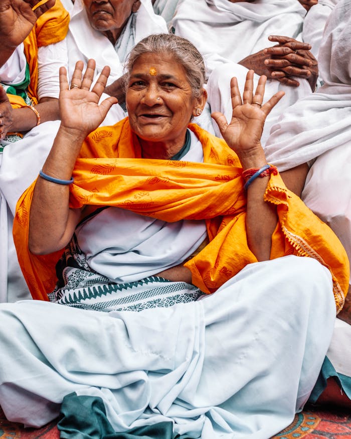 Joyful senior woman participating in Holi festival, Vrindavan, India